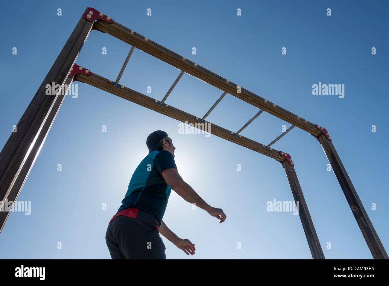 Man using outdoor beach gym in Spain Stock Photo