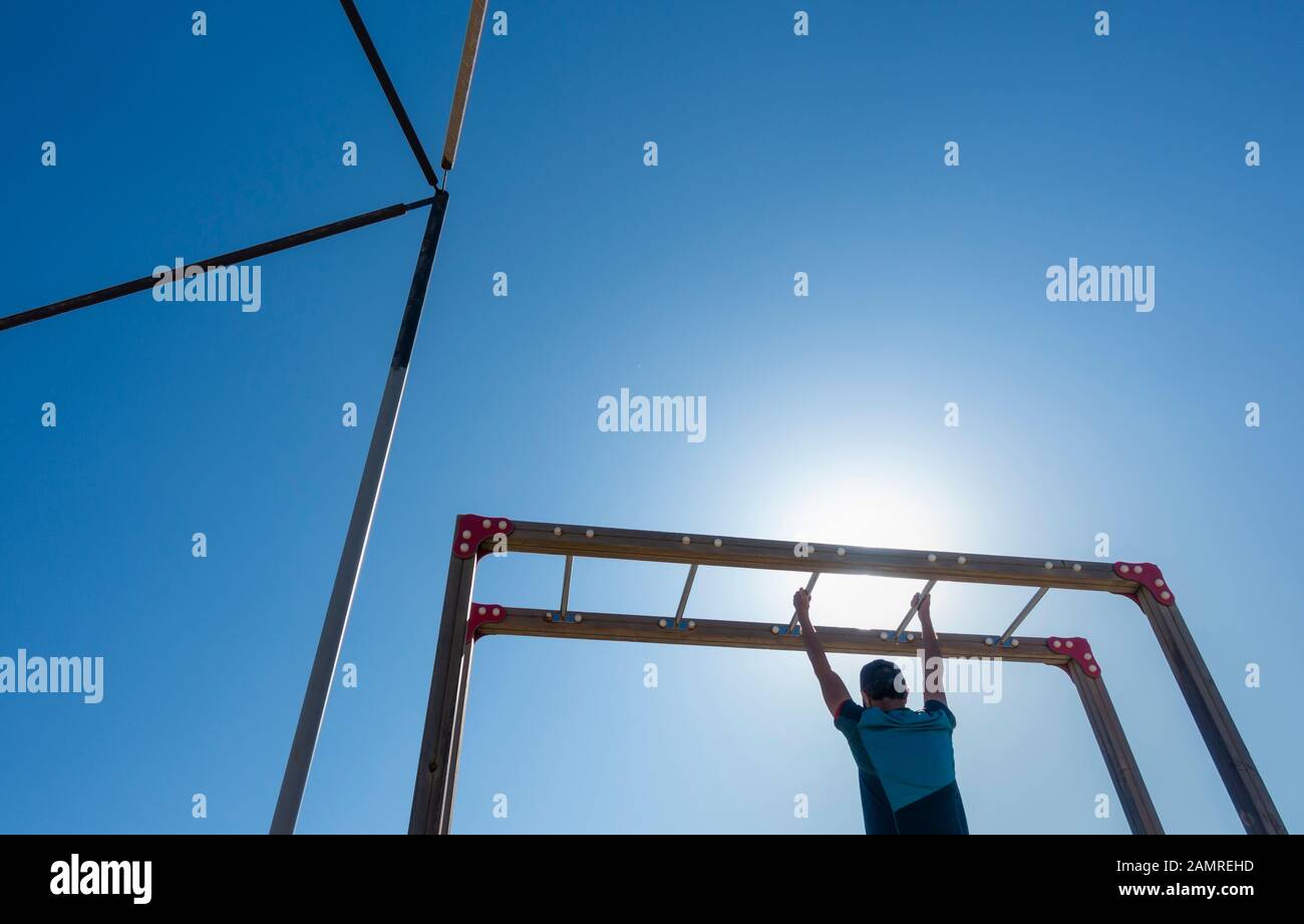 Man using outdoor beach gym in Spain Stock Photo