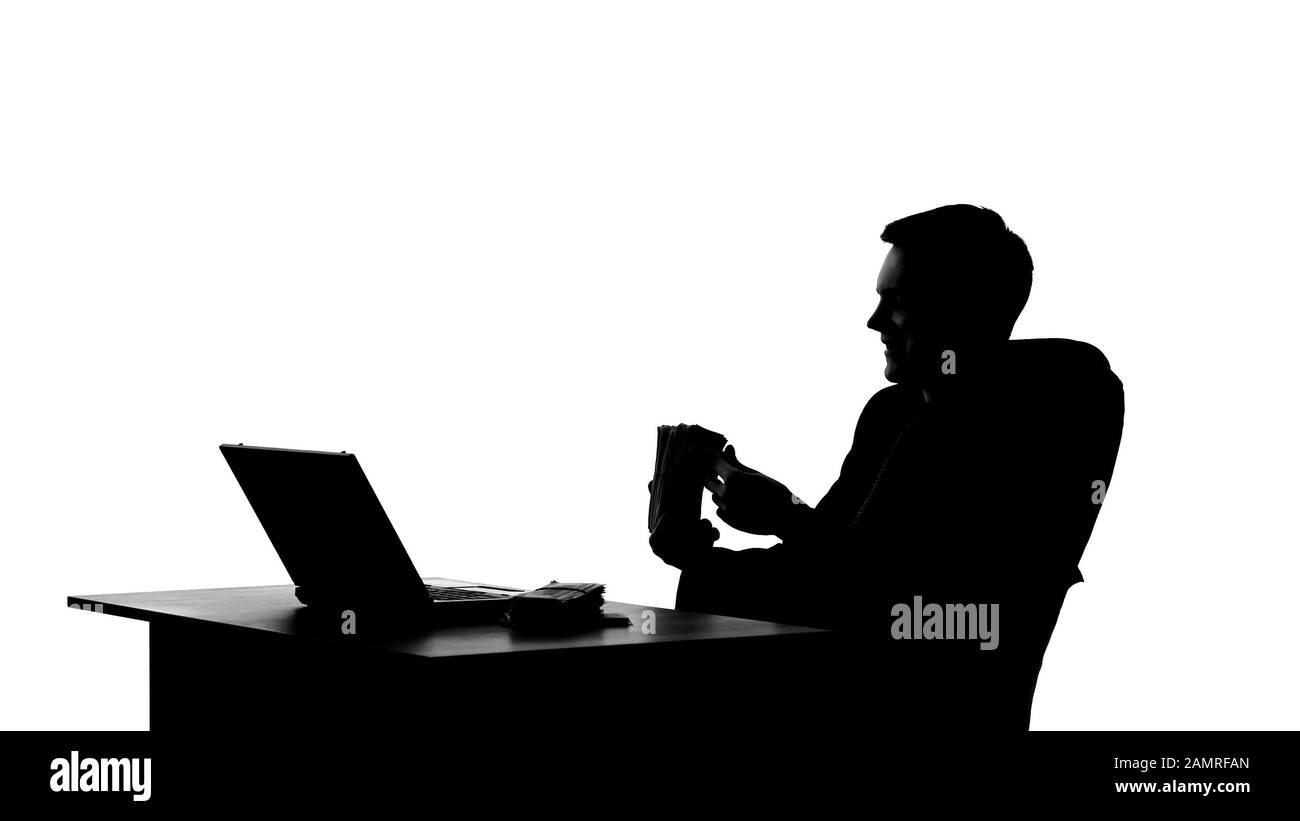 Businessman sitting in office and counting bundle of money, oligarch shadow Stock Photo