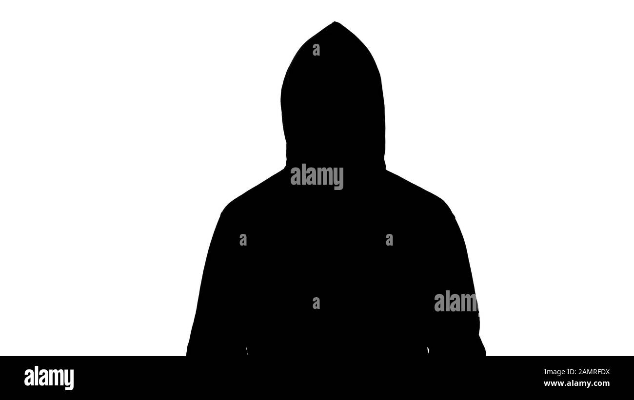 Dark male silhouette in hood looking into camera, preparing to attack, hooligan Stock Photo