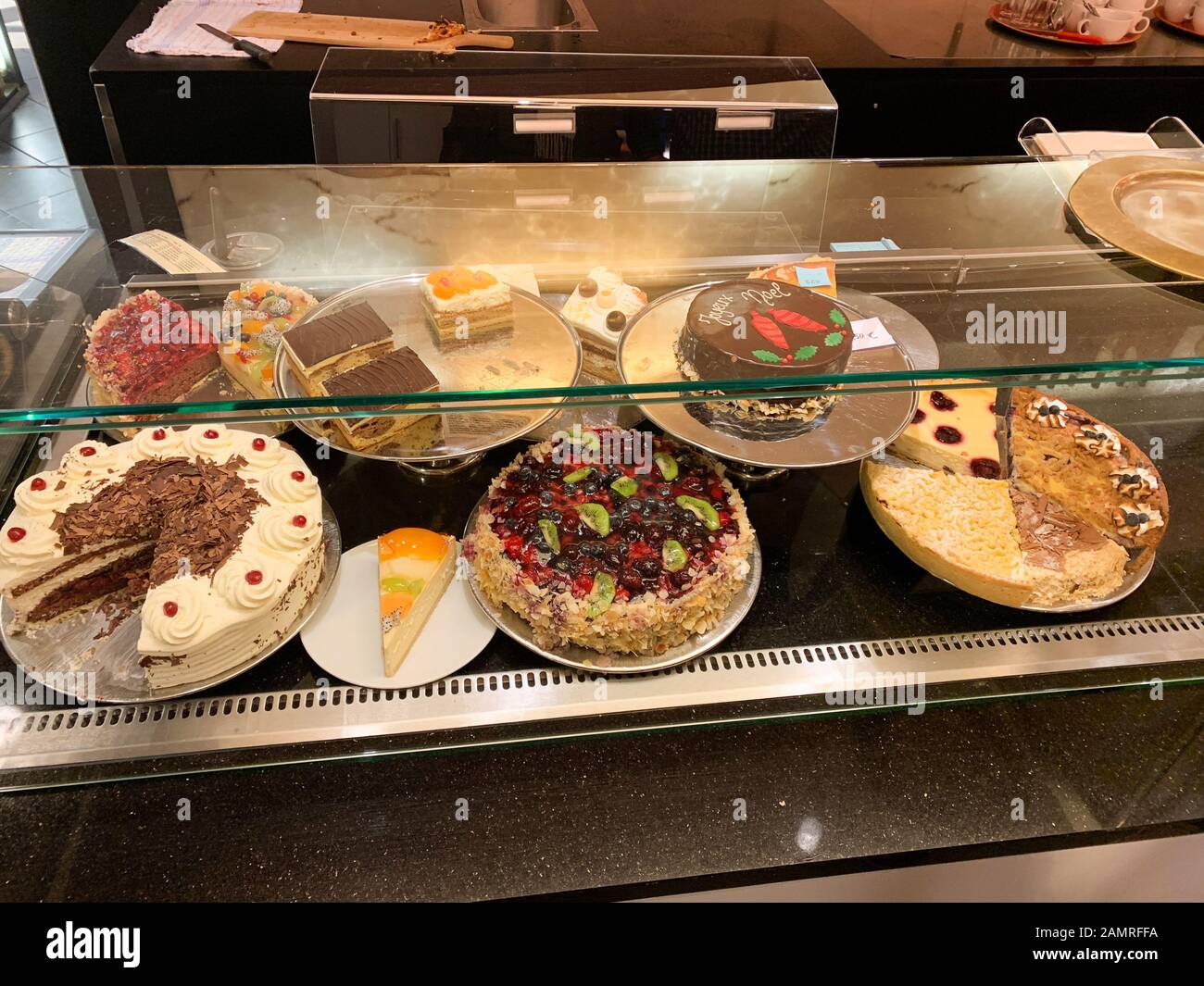 Multiple traditional French cakes tarts with sweet cream and fruits for