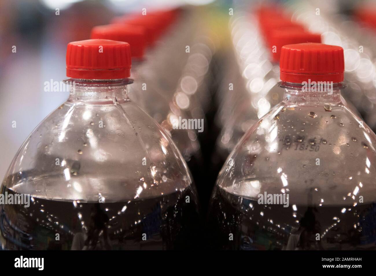 Fizzy sugar drinks for sale in plastic bottles in a UK supermarket