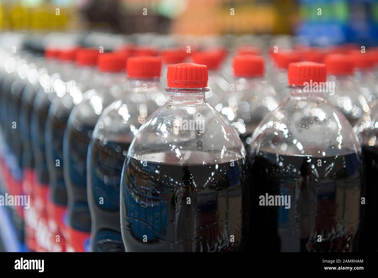 Fizzy sugar drinks for sale in plastic bottles in a UK supermarket