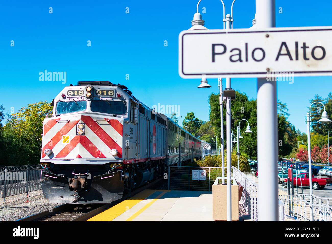 EMD F40PH diesel locomotive in Caltrain livery is approaching Palo Alto train station - Palo Alto California, USA - Circa 2019 Stock Photo