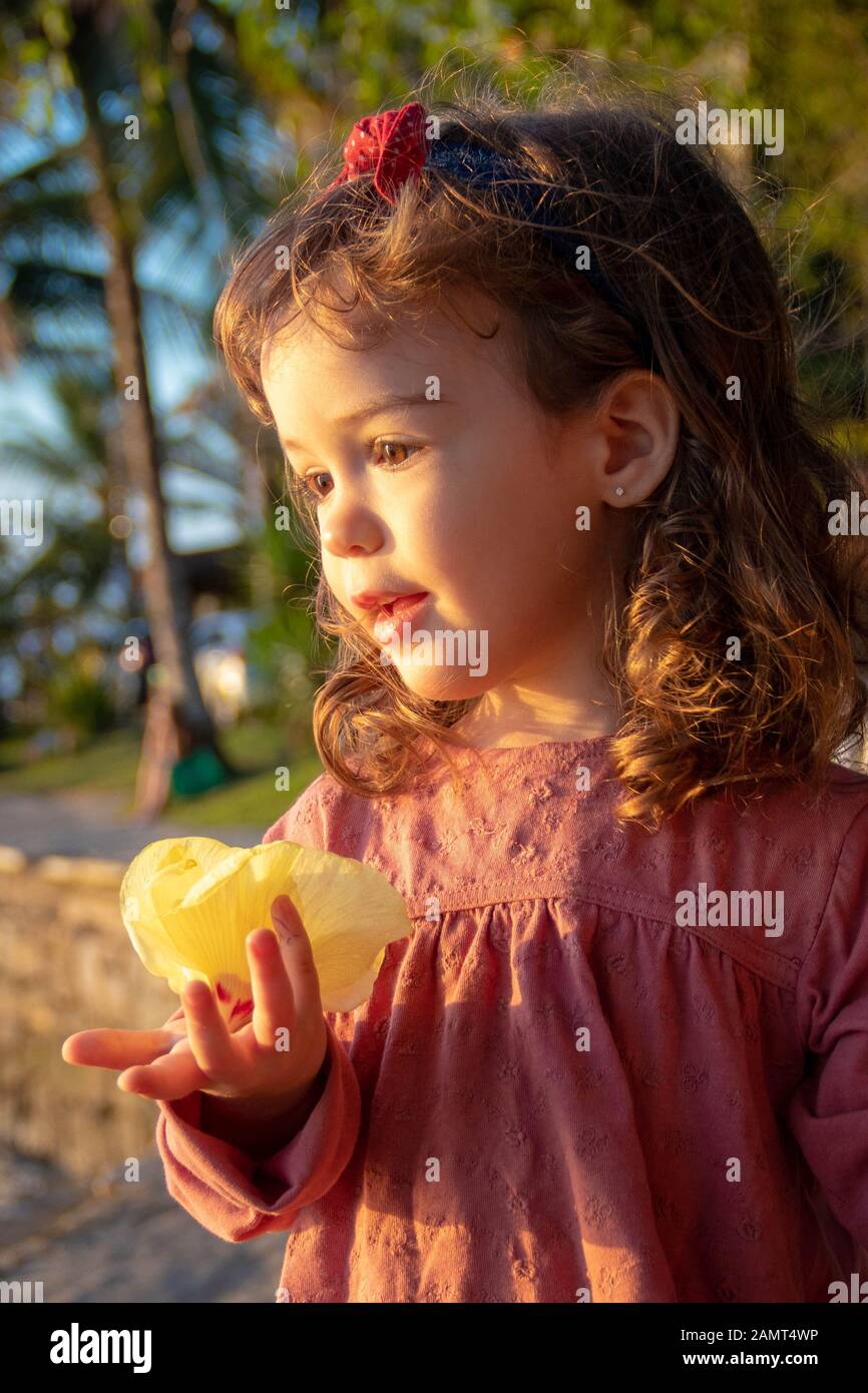 Portrait of a girl holding a flower, Brazil Stock Photo