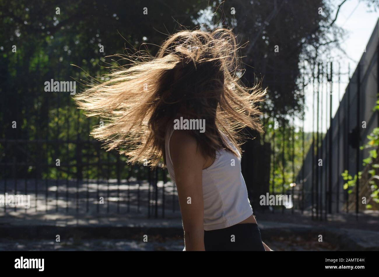 Teenage girl standing in the street spinning around, Argentina Stock Photo