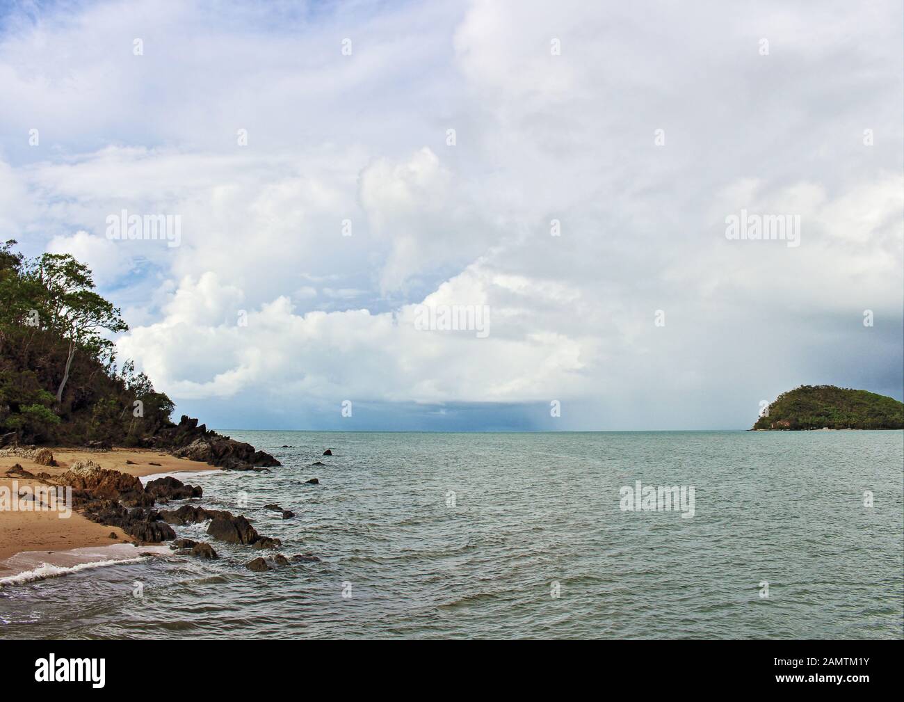 Wet season pic of the Palm Cove headland and channel as a tropical rain squall hits just off Double Island Stock Photo