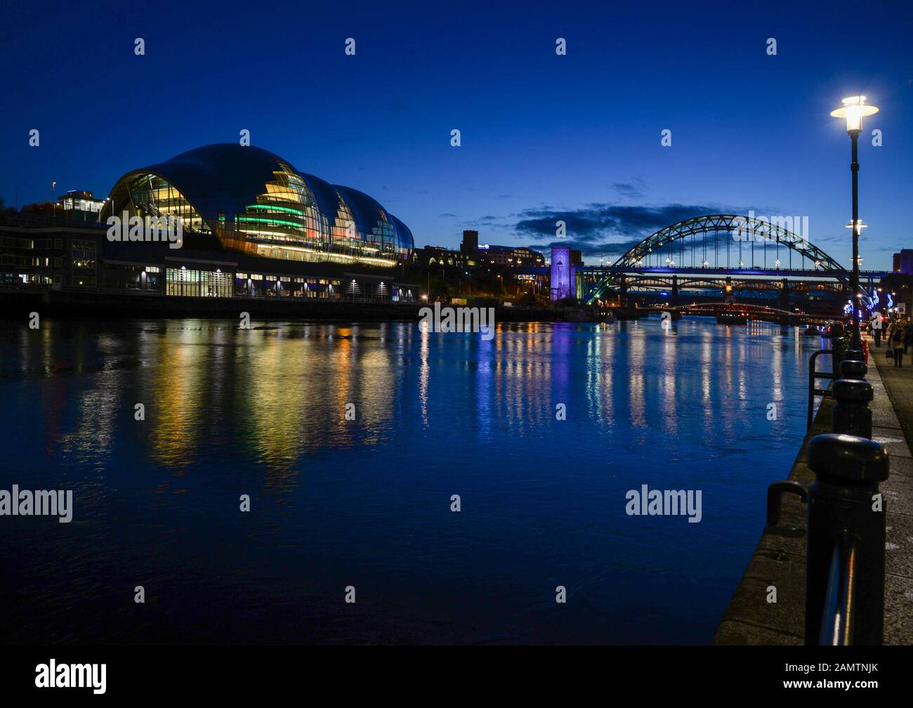 Looking across the River Tyne from Newcastle Quayside to the Sage Theatre in Gateshead on the south side of the river with the Tyne Bridge beyond. Stock Photo