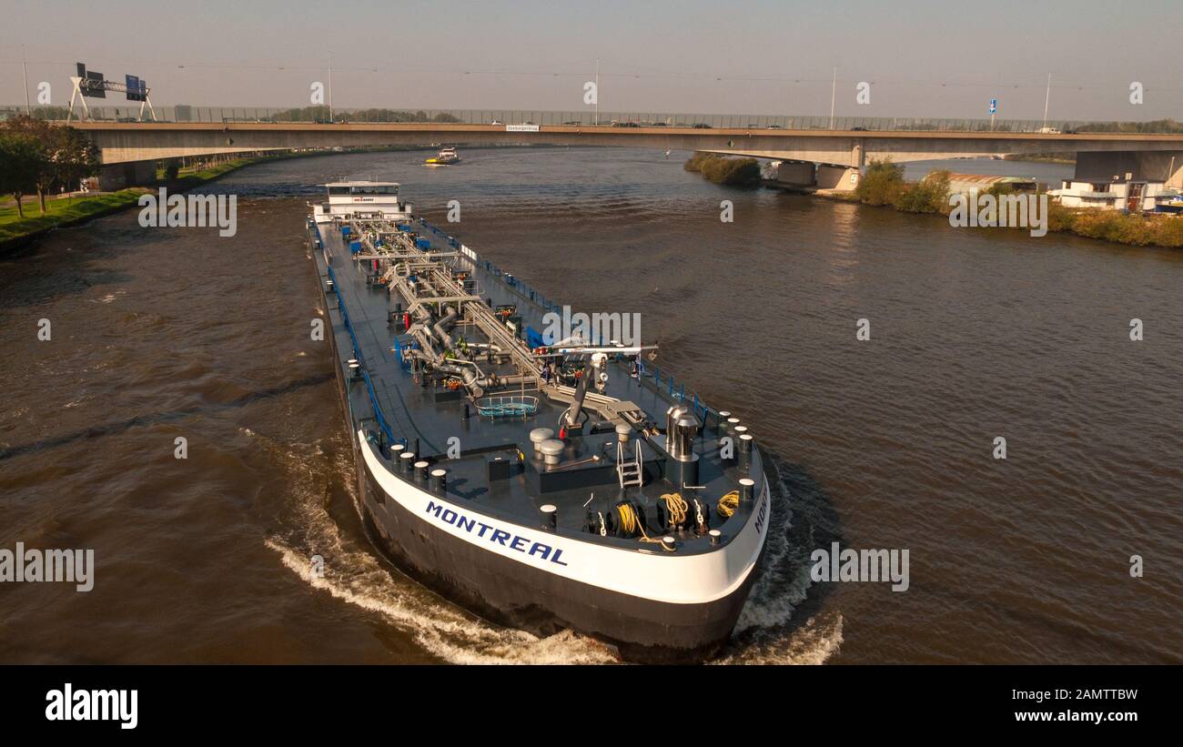 Amsterdam, Netherlands - October 2, 2011: Cargo barges pass under the A10 motorway on the Amsterdam–Rhine Canal, as viewed from Nesciobrug in the sout Stock Photo