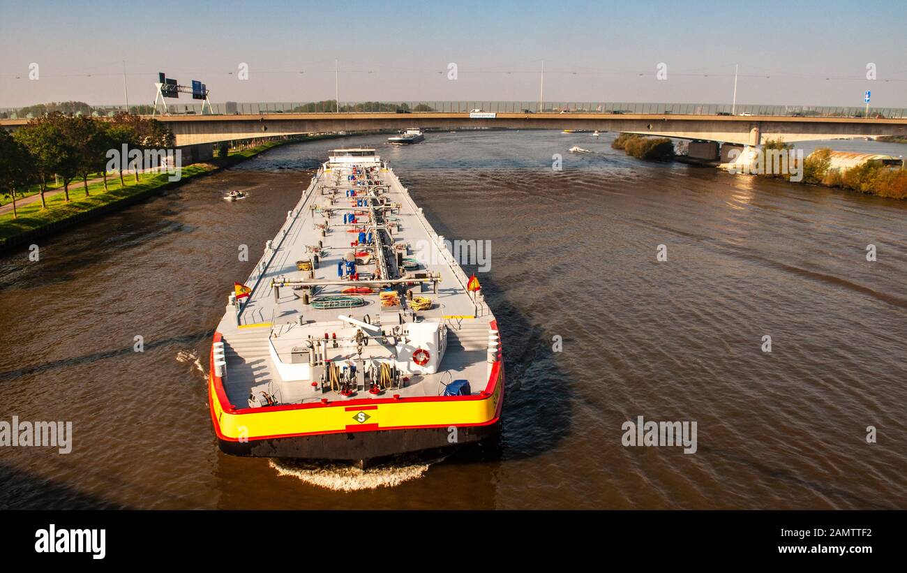 Amsterdam, Netherlands - October 2, 2011: Cargo barges pass under the A10 motorway on the Amsterdam–Rhine Canal, as viewed from Nesciobrug in the sout Stock Photo