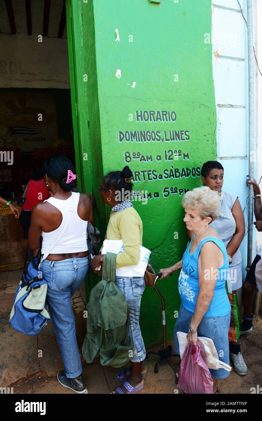 Cubans waiting in line to buy bread as part of ration program by the Cuban government. Stock Photo