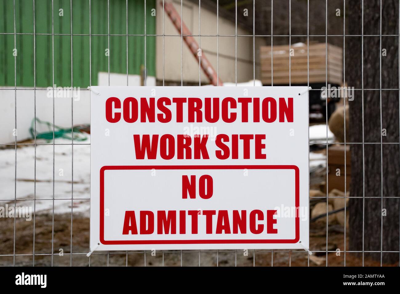 A construction work site sign on a wire fence in Speculator, NY USA Stock Photo