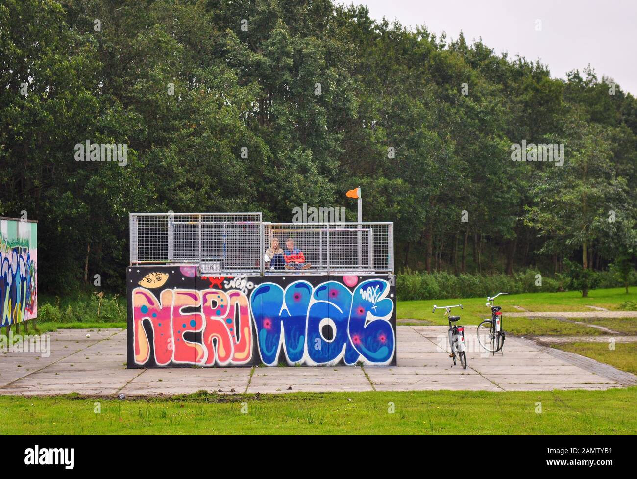 Assen, Netherlands - September 20, 2011: Teenagers with bicycles hang out at a skate ramp in Kloosterveen in Assen in the Netherlands. Stock Photo