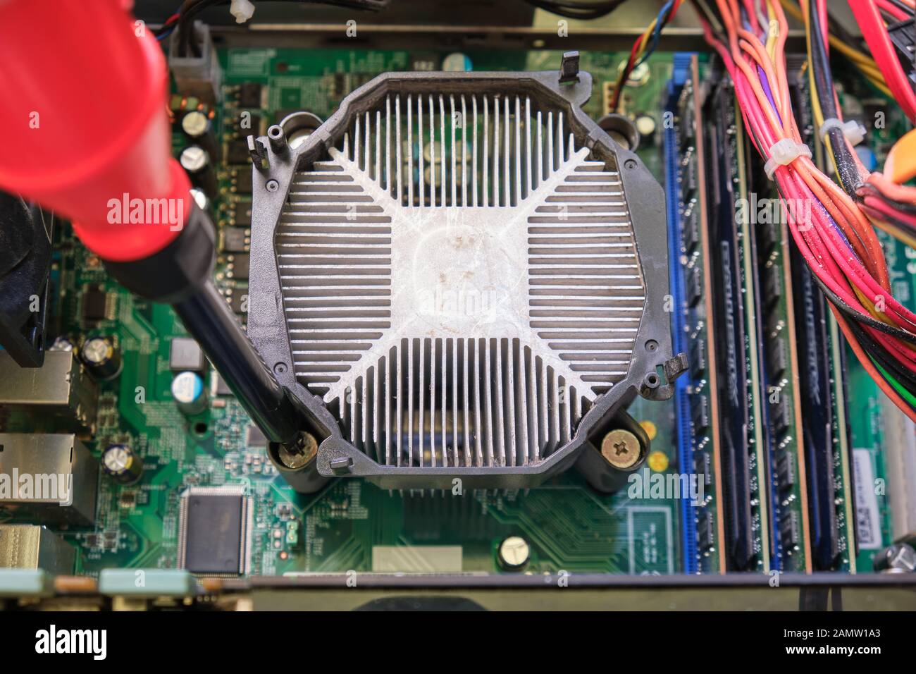 Tightening screw of a CPU heatsink placed on a computer motherboard