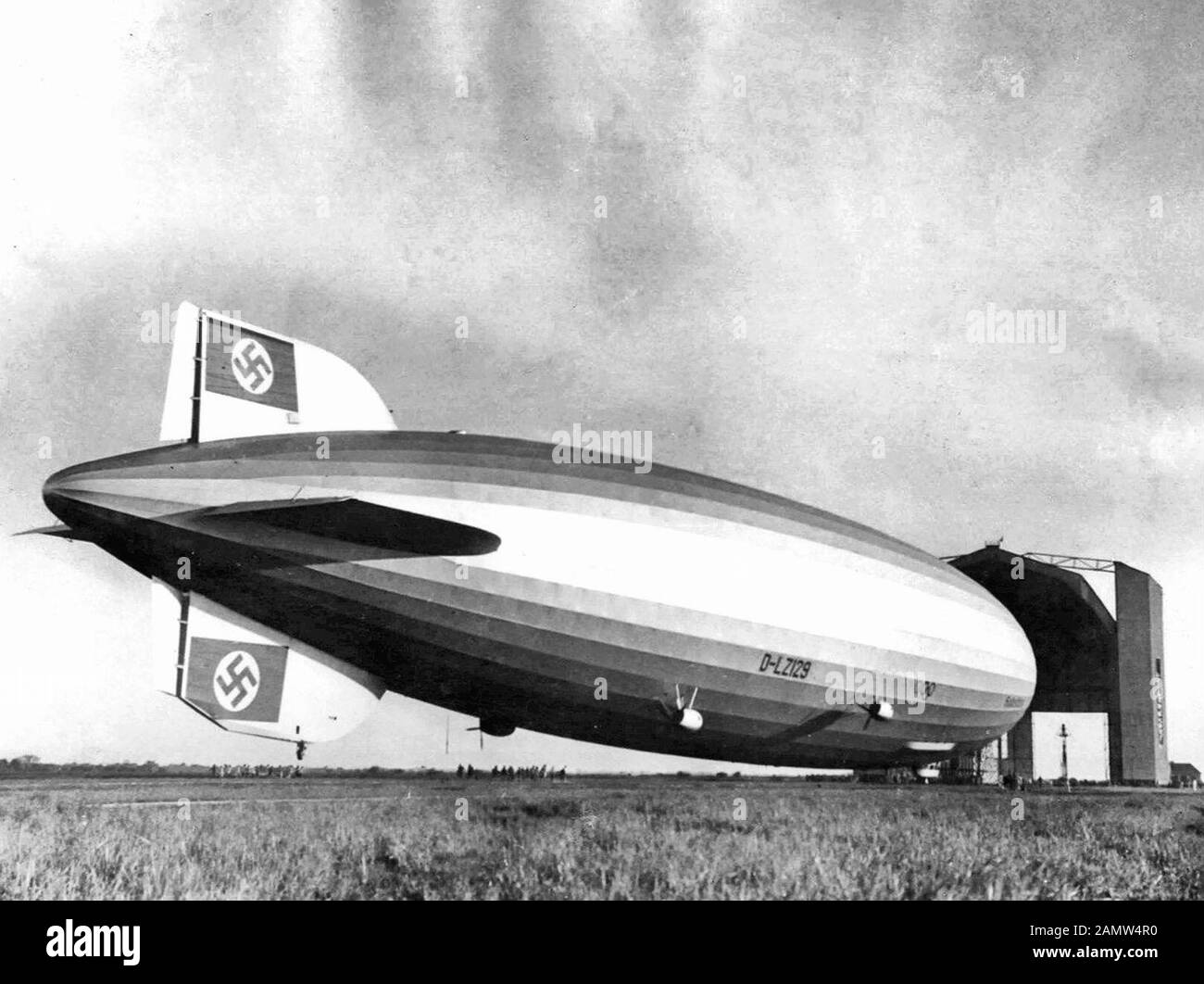 Photo of the Hindenburg entering the airship hangar at Santa Cruz, Rio De Janiero, Brazil, following its first transatlantic crossing in April of 1936. Note the temporary tail fin repair after the fin was damaged during a propaganda flight in Germany on March 26, 1936. Stock Photo