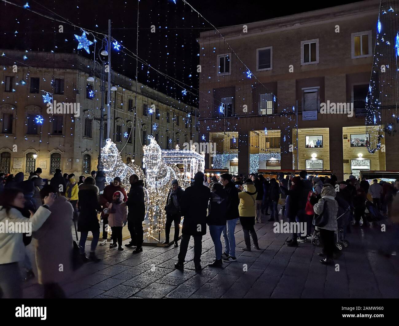 Christmas decorations and people at night in Sant'Oronzo square in