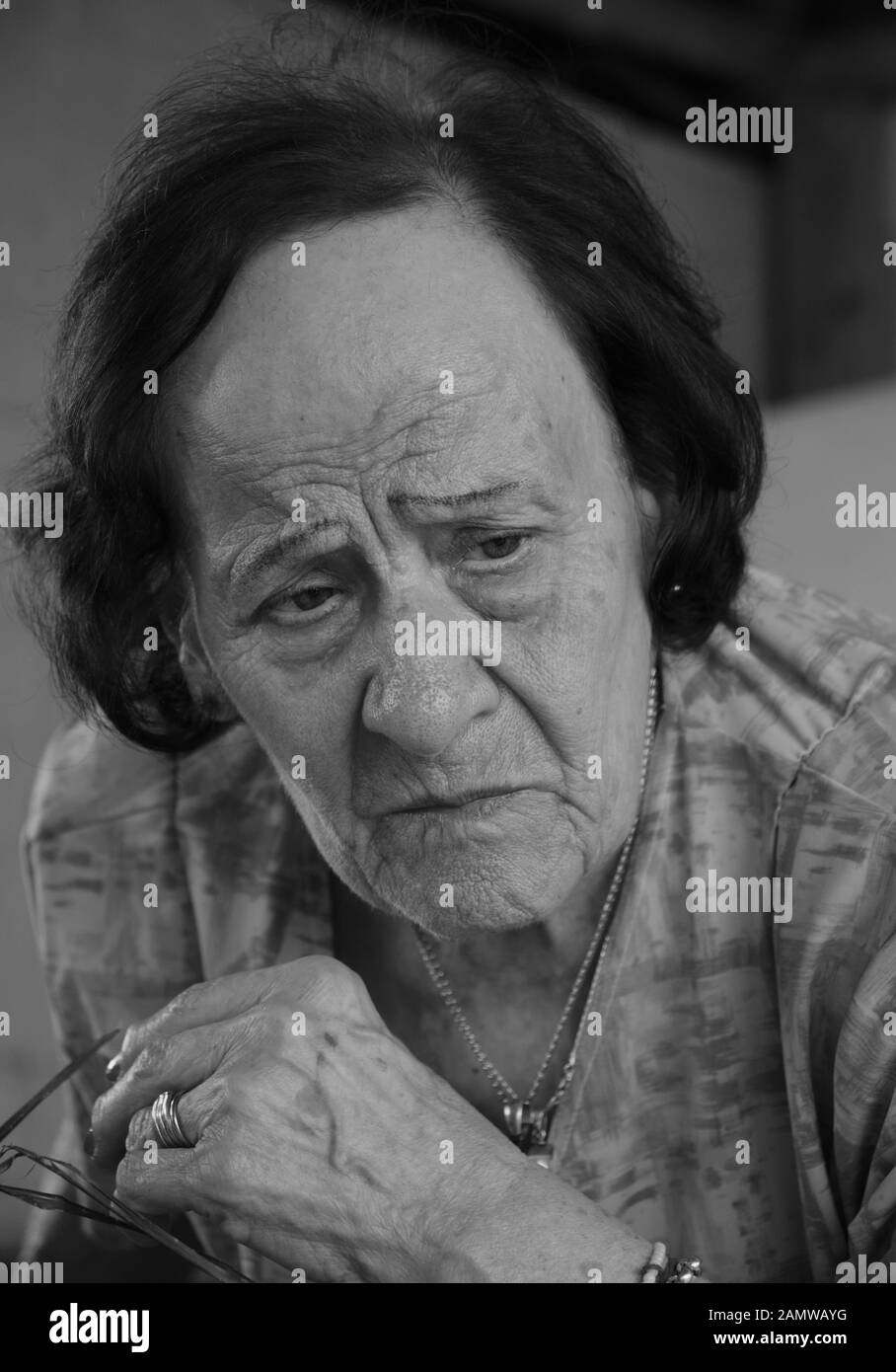 a black and white portrait of an old woman making an expression of angry Stock Photo