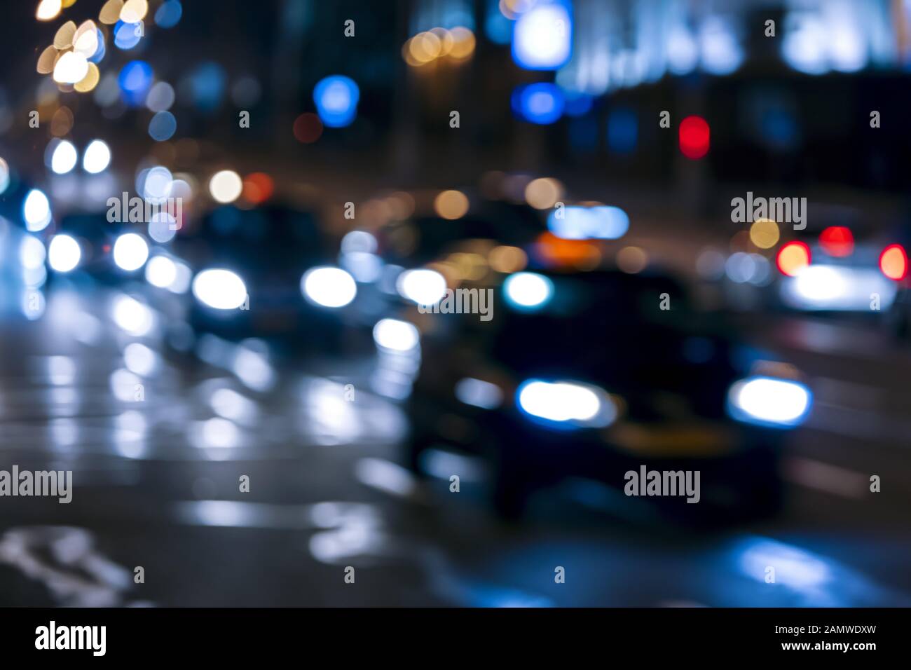 car traffic at night street. blurred street lights and car headlights Stock Photo