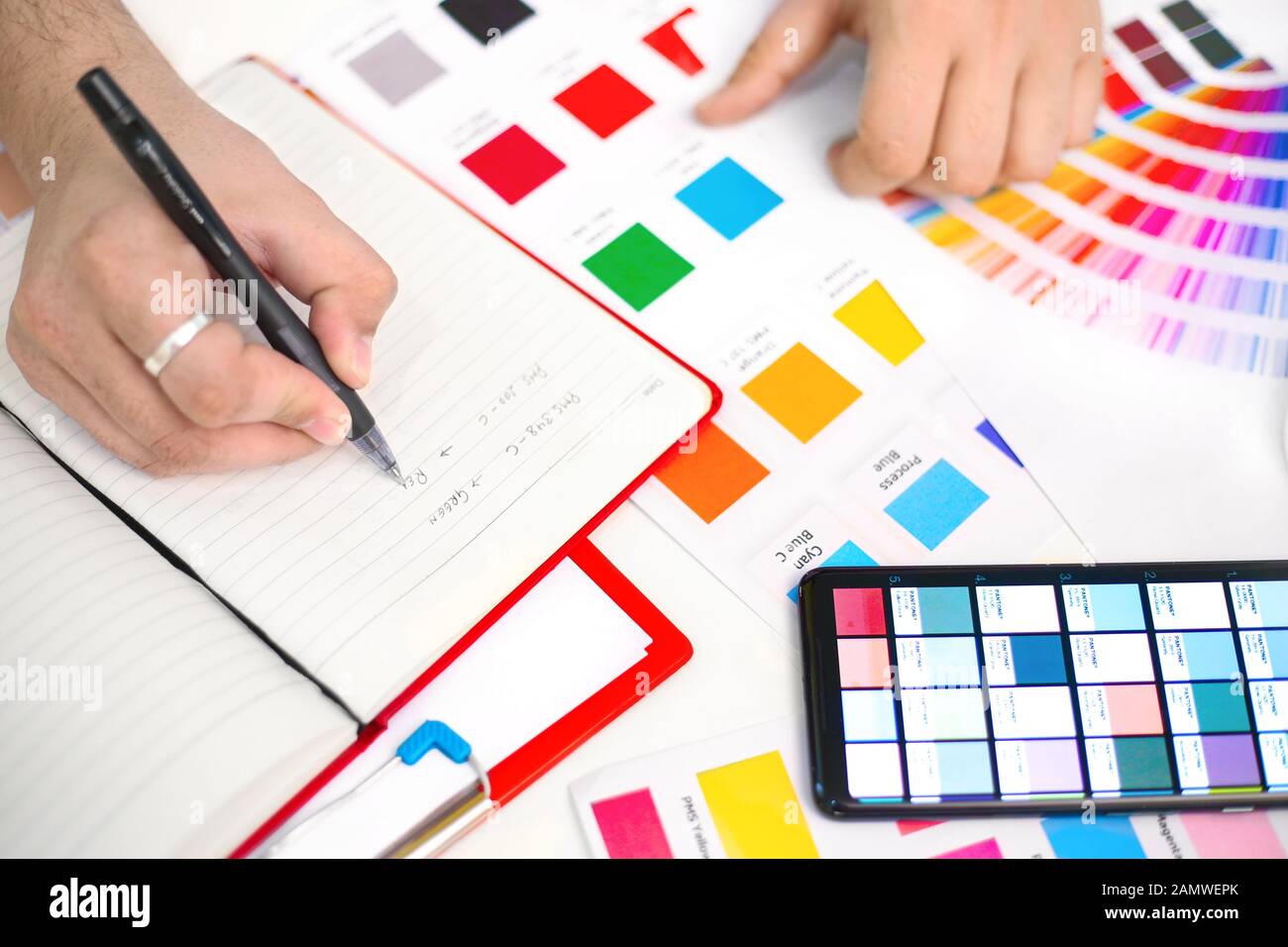 Picture of pantone with man hands choosing colors. Isolated on white background. Stock Photo