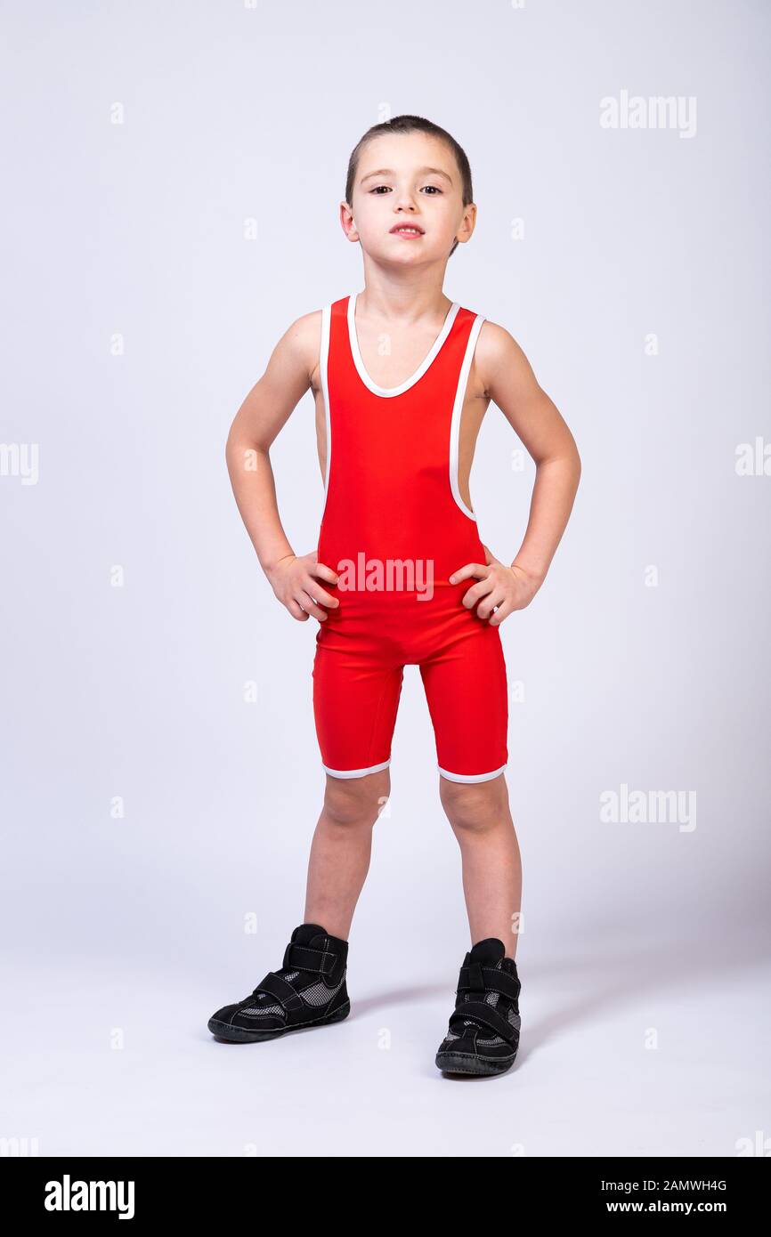 A boy athlete in sportswear and wrestling outfits is standing straight with  his hands on his sides and looking at the camera on a white isolated backg  Stock Photo - Alamy