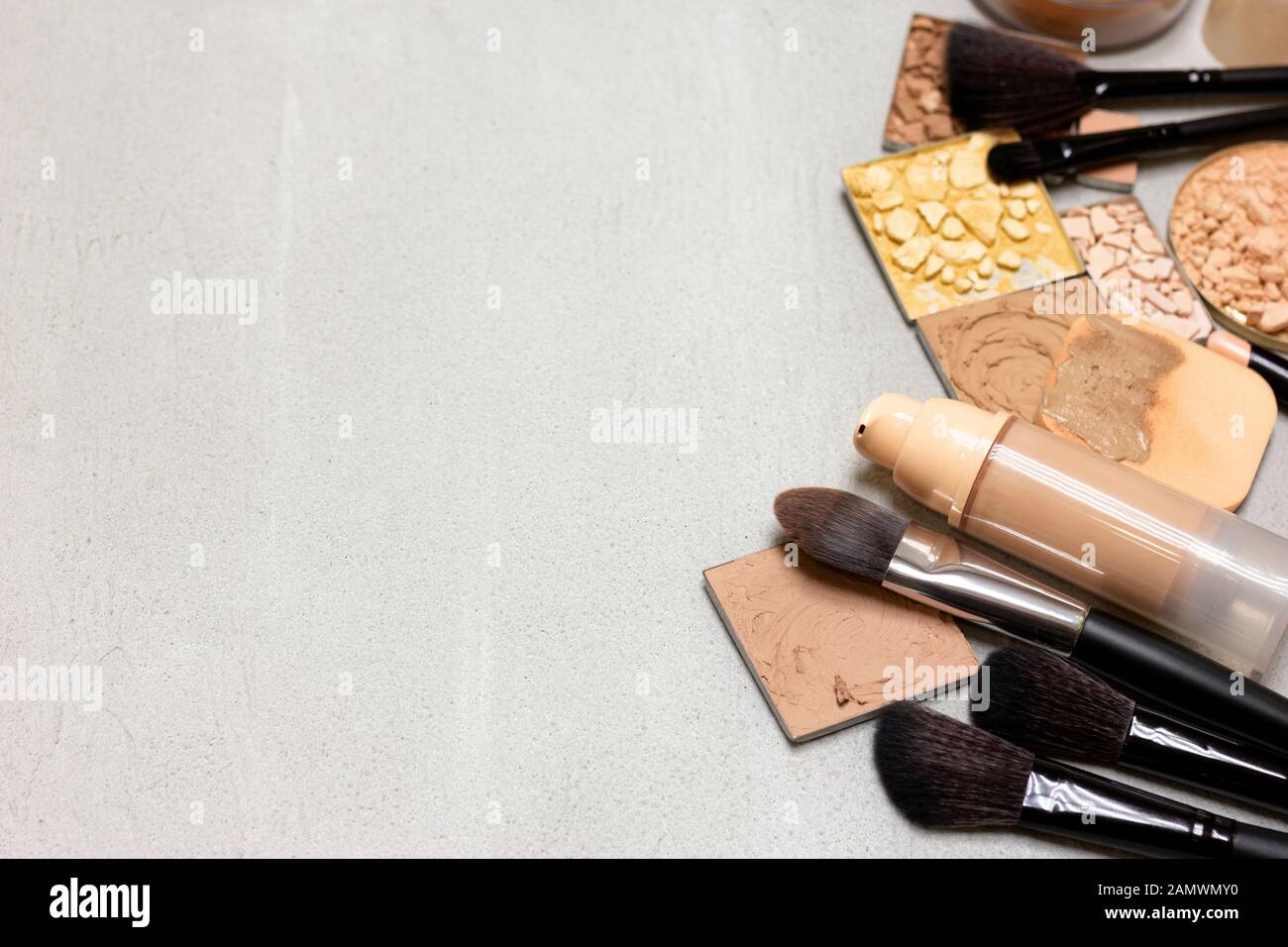 Makeup background. Make-up foundation, concealer, various powders on  concrete surface. Side frame layout with empty space Stock Photo - Alamy