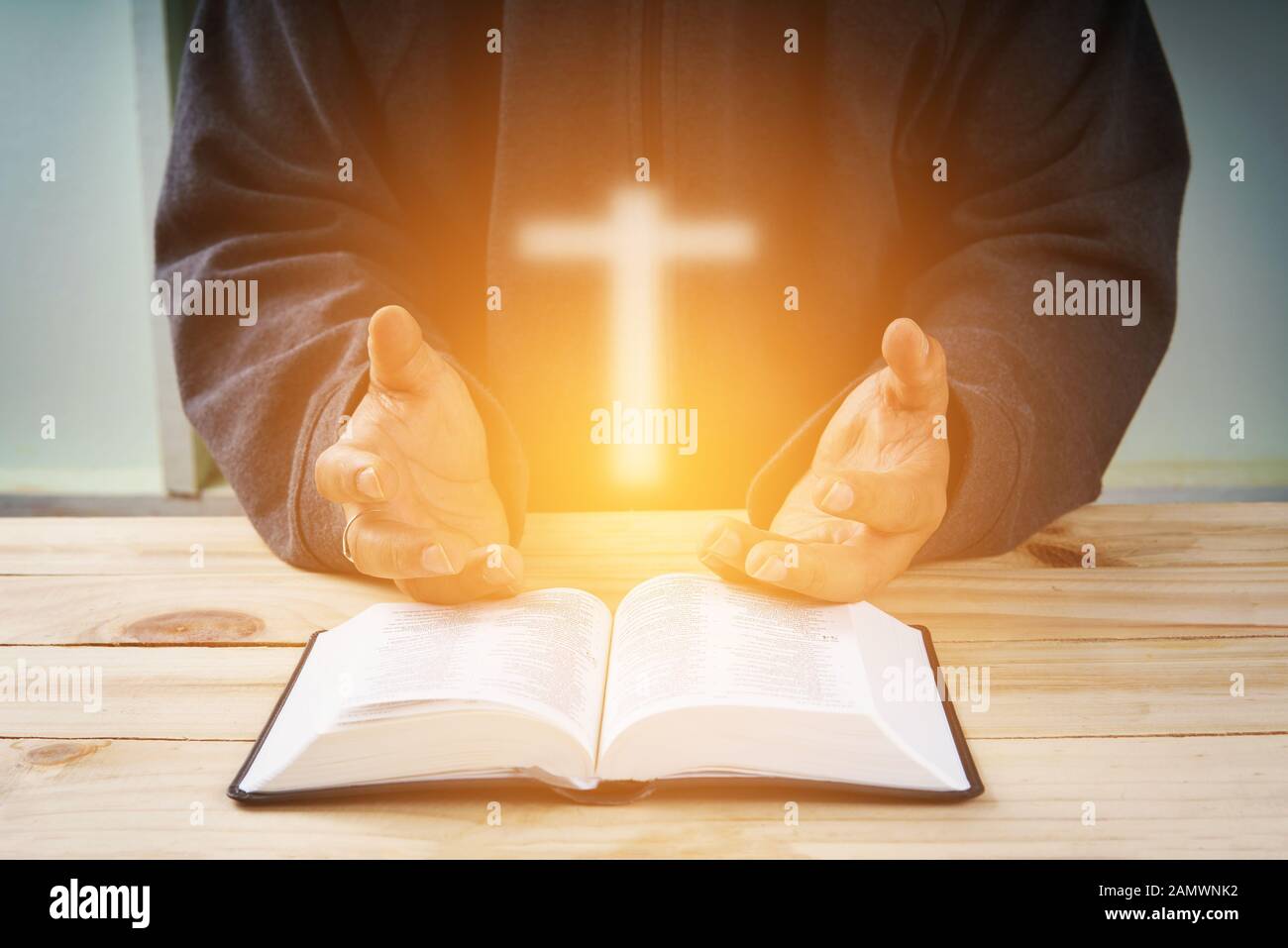 Christian hand while praying and worship for christian religion with  blurred of her body background, Casual man praying with her hands together  over a Stock Photo - Alamy