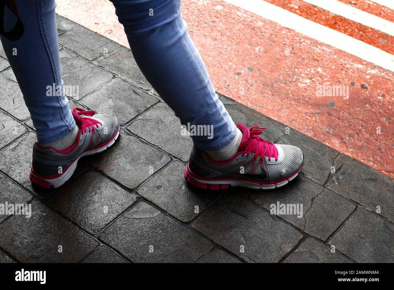 Antipolo City, Philippines - January 10, 2020: Lady wearing colorful running  shoes and skinny jeans stand on concrete floor Stock Photo - Alamy
