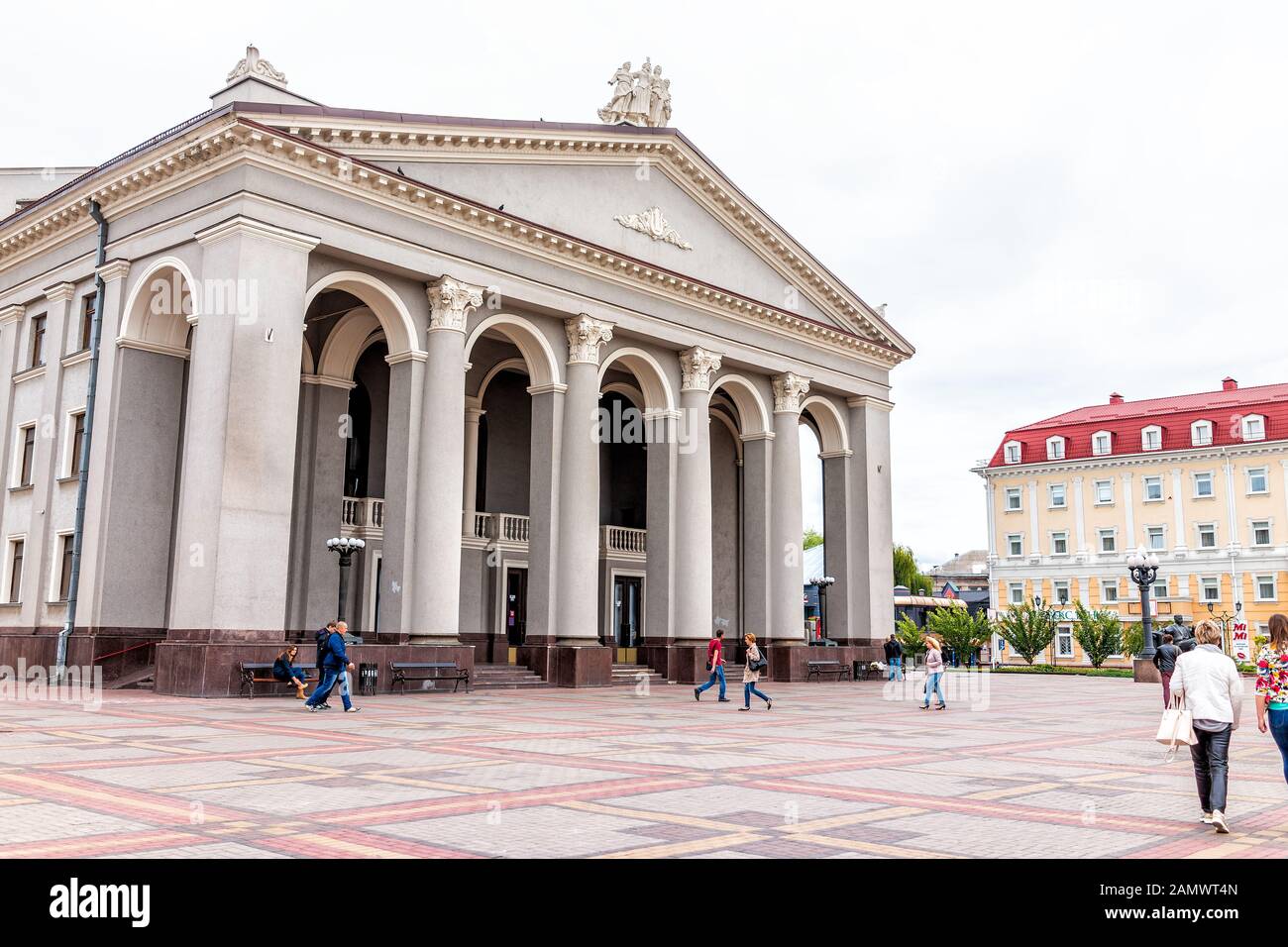 Rivne, Ukraine - July 3, 2018: Main square with theater Rovno Soviet architecture city in western Ukraine outdoor park in summer and people walking Stock Photo