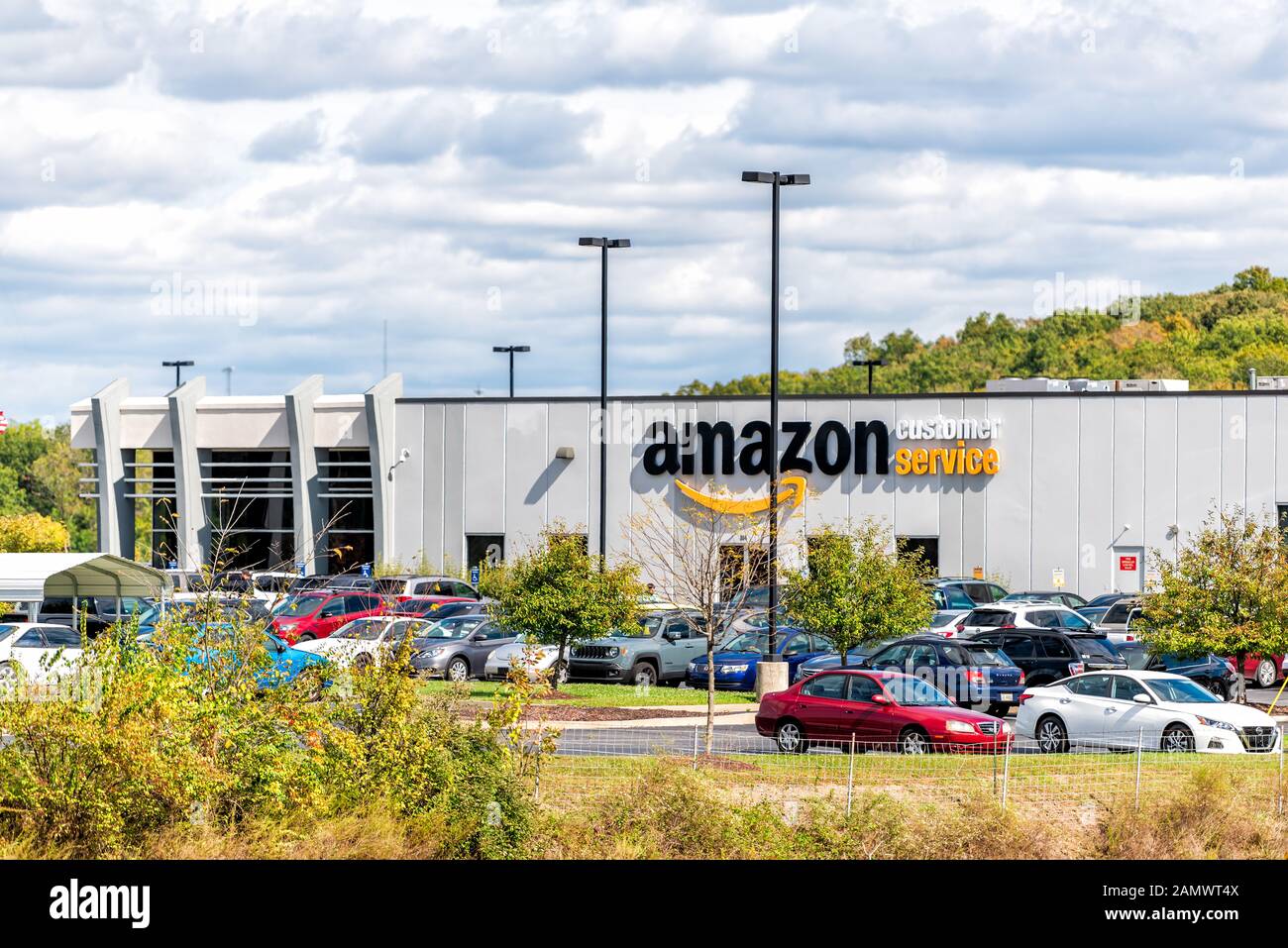 Huntington, USA - October 17, 2019: Amazon Customer Service center sign on exterior building in city in West Virginia with parking lot cars Stock Photo