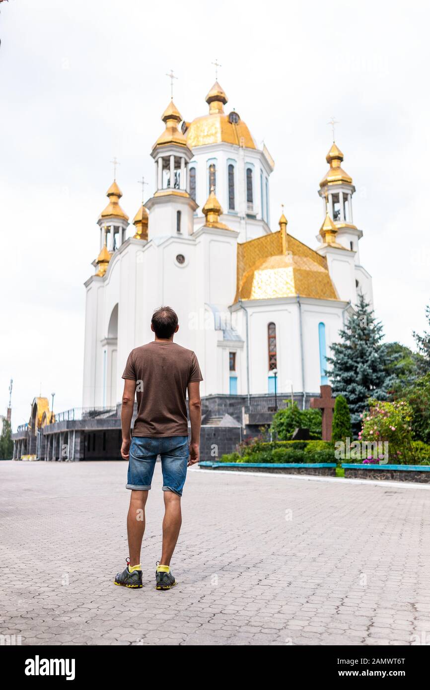 Rivne, Ukraine - July 3, 2018: Soborna and Lypnya street in Rovno city town in western Ukraine in summer and man looking at St Basil Cathedral UOC-KP Stock Photo