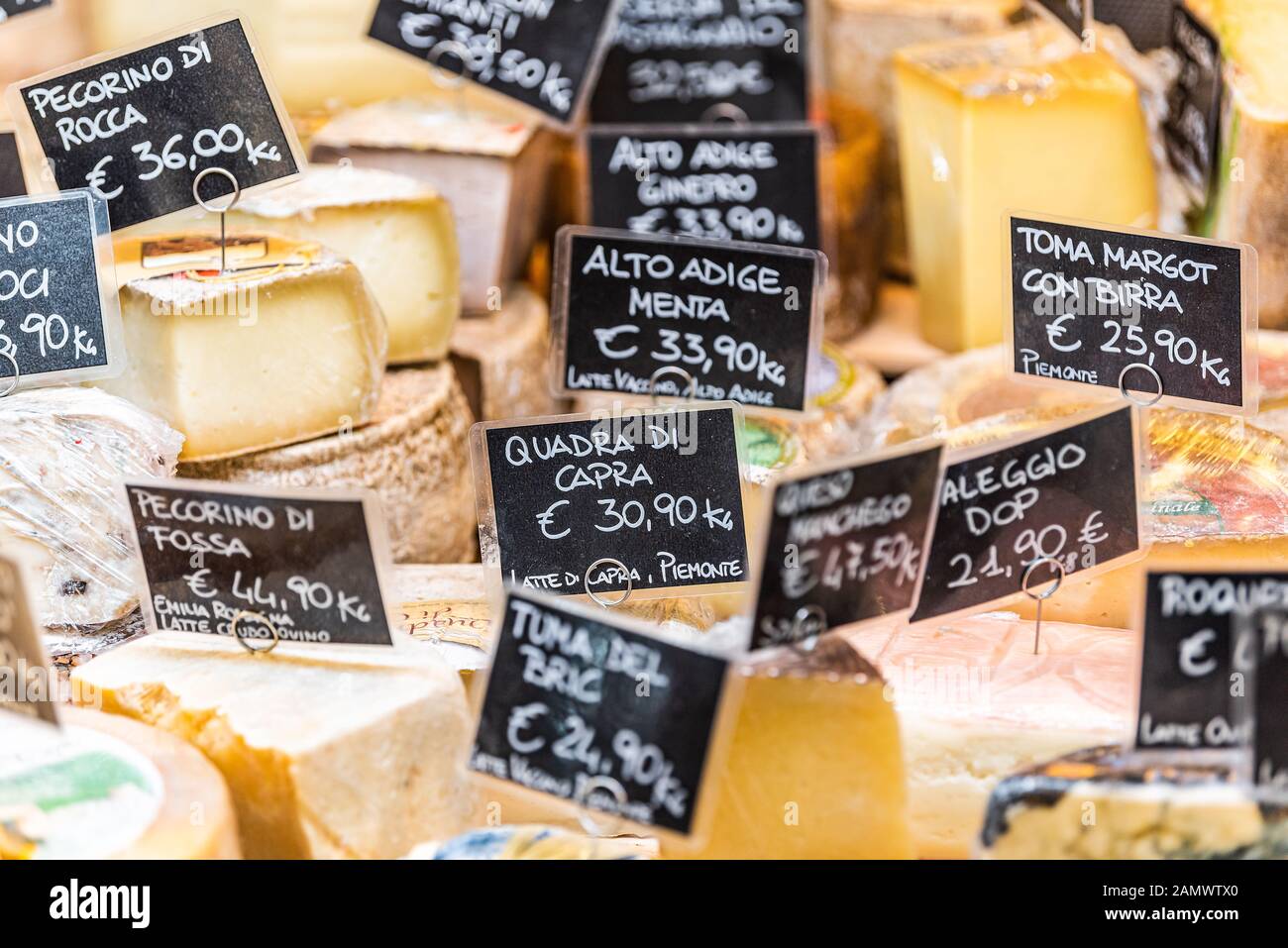Florence, Italy - August 30, 2018: Many varieties of Italian cheese food on display in Firenze Italy central market with sign prices Stock Photo