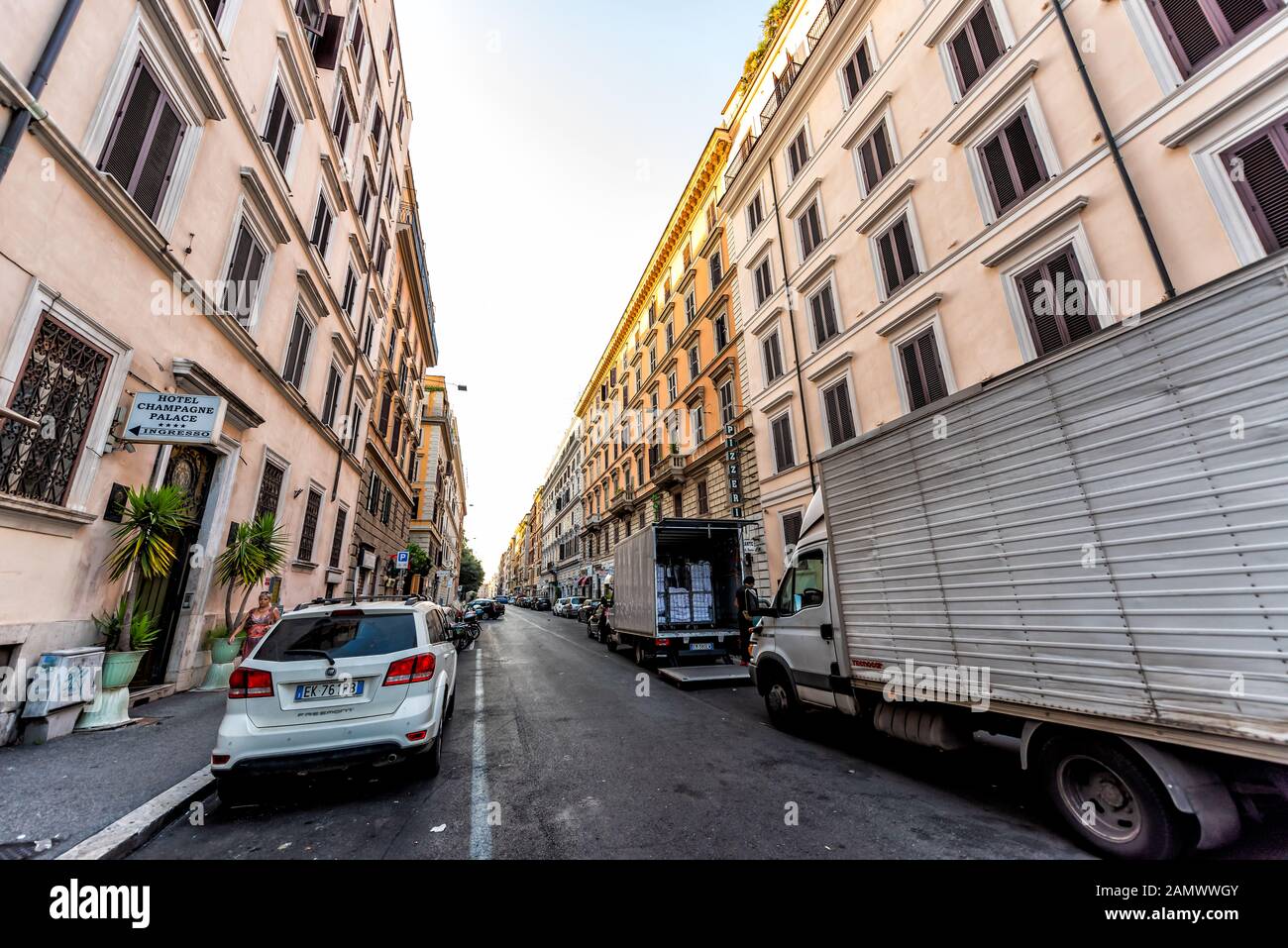 Rome, Italy - September 5, 2018: Italian street outside in city morning wide angle road with delivery trucks on Via Principe Amedeo with hotel sign Stock Photo