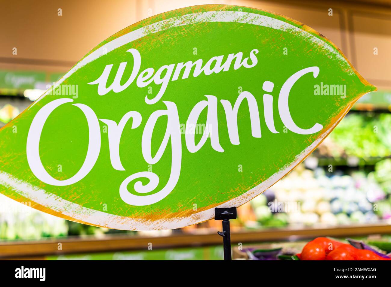 Fairfax, USA - December 5, 2019: Wegmans grocery store interior with closeup of organic sign text in produce aisle with vegetables fruits Stock Photo