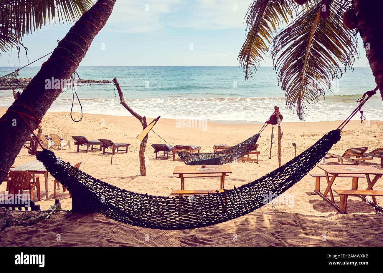 Tropical beach with hammock, color toning applied, Sri Lanka Stock