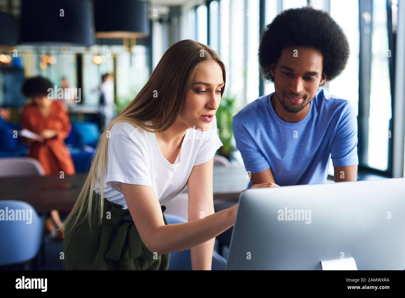 Young couple working with technology in the office Stock Photo