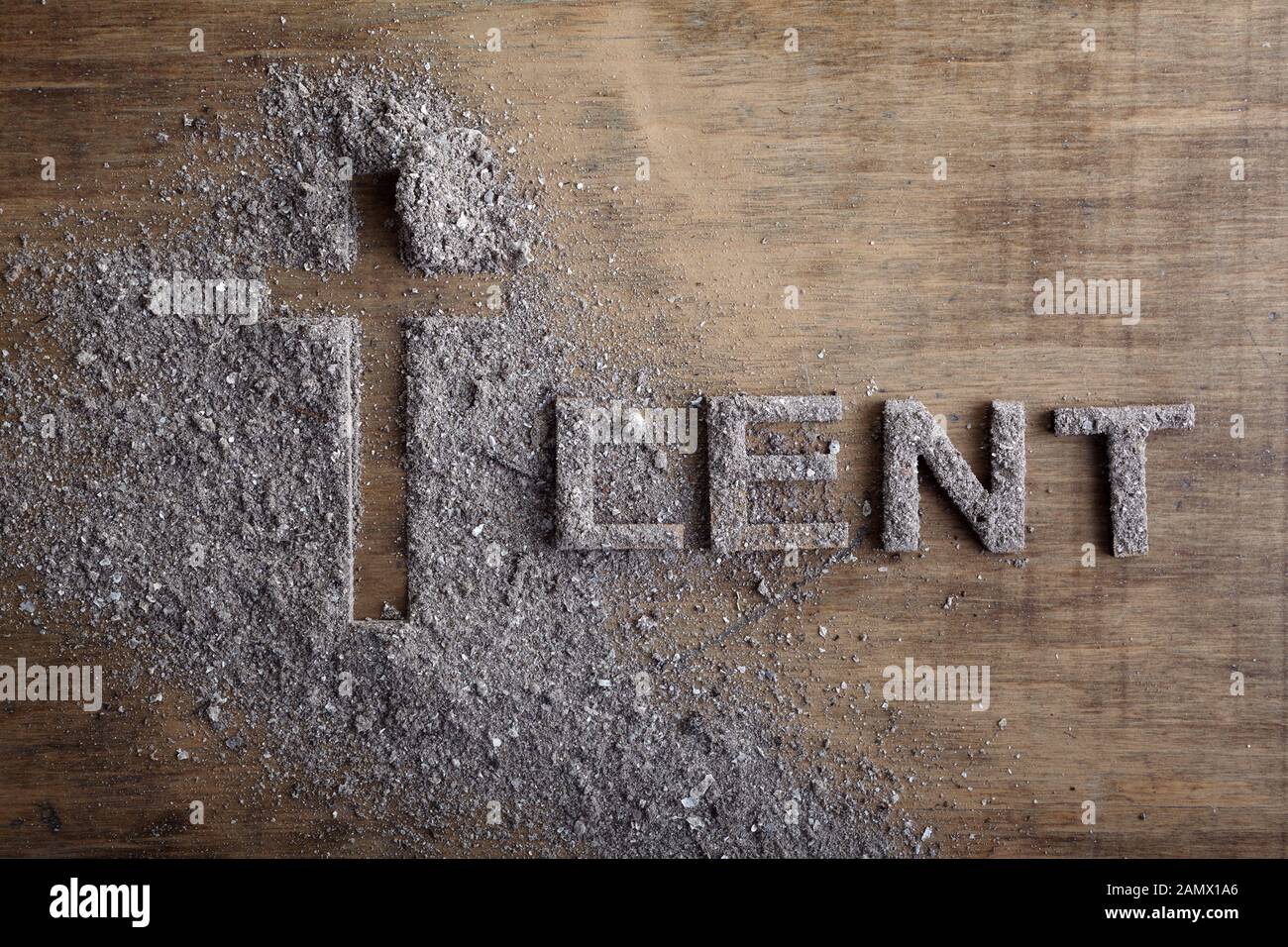 Lent word written in ash, dust as fast and abstinence period concept. Top view Stock Photo