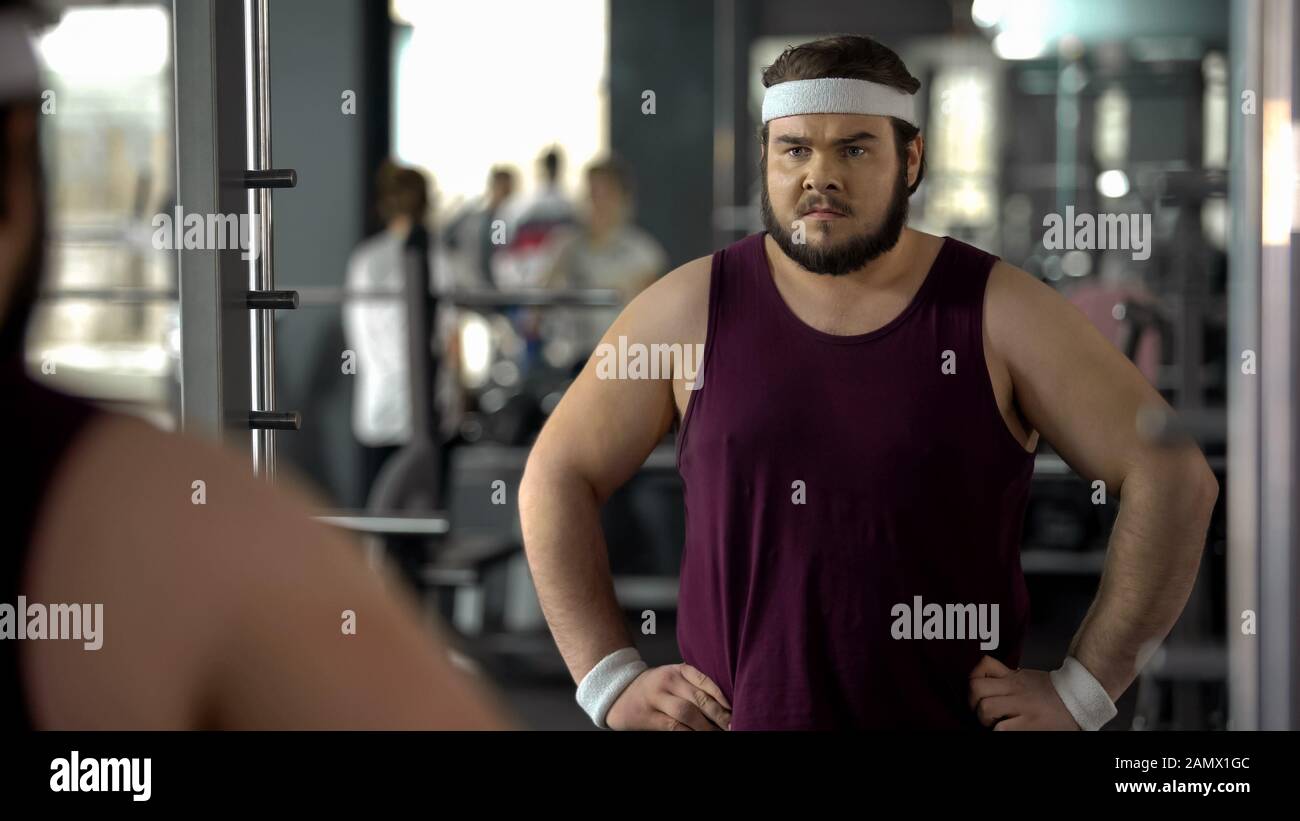 Fat man looking disappointed because of bad result after weight loss trainings Stock Photo