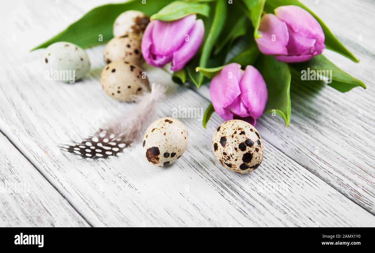 easter background with eggs and pink tulips Stock Photo - Alamy
