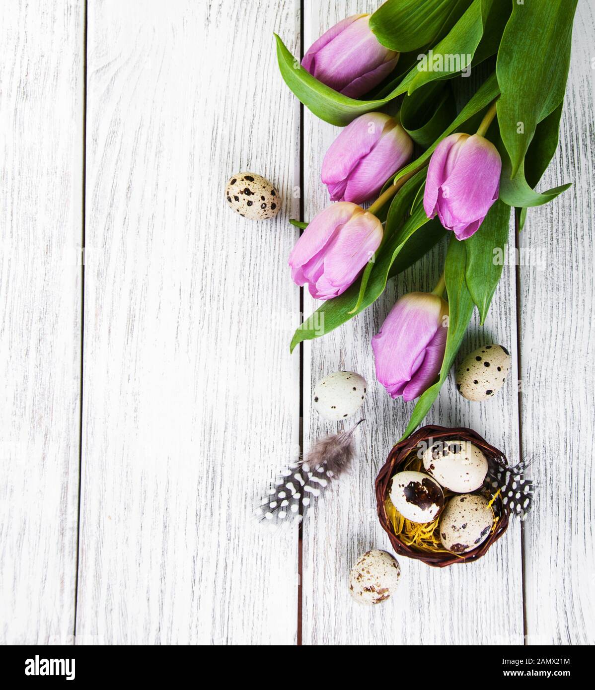 easter background with eggs in nest and pink tulips Stock Photo - Alamy
