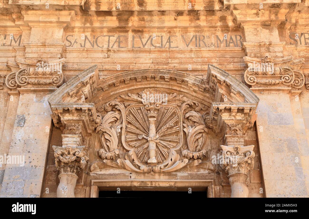 Coat of arms, bas relief at facade of Chiesa di Santa Lucia alla badia Stock Photo