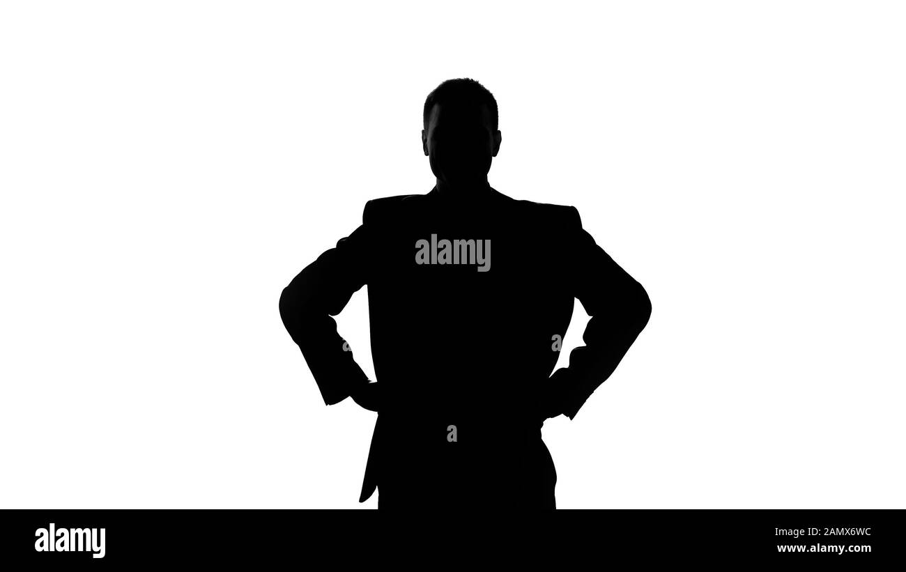 Silhouette of businessman holding hands on his hip, seriousness of intentions Stock Photo