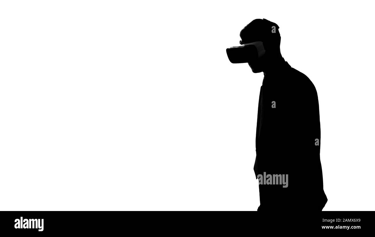 Male silhouette in virtual reality headset playing video game, sport simulator Stock Photo