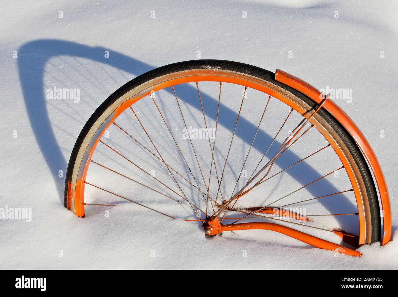 An old bicycle has got buried under white soft snowdrift Stock Photo
