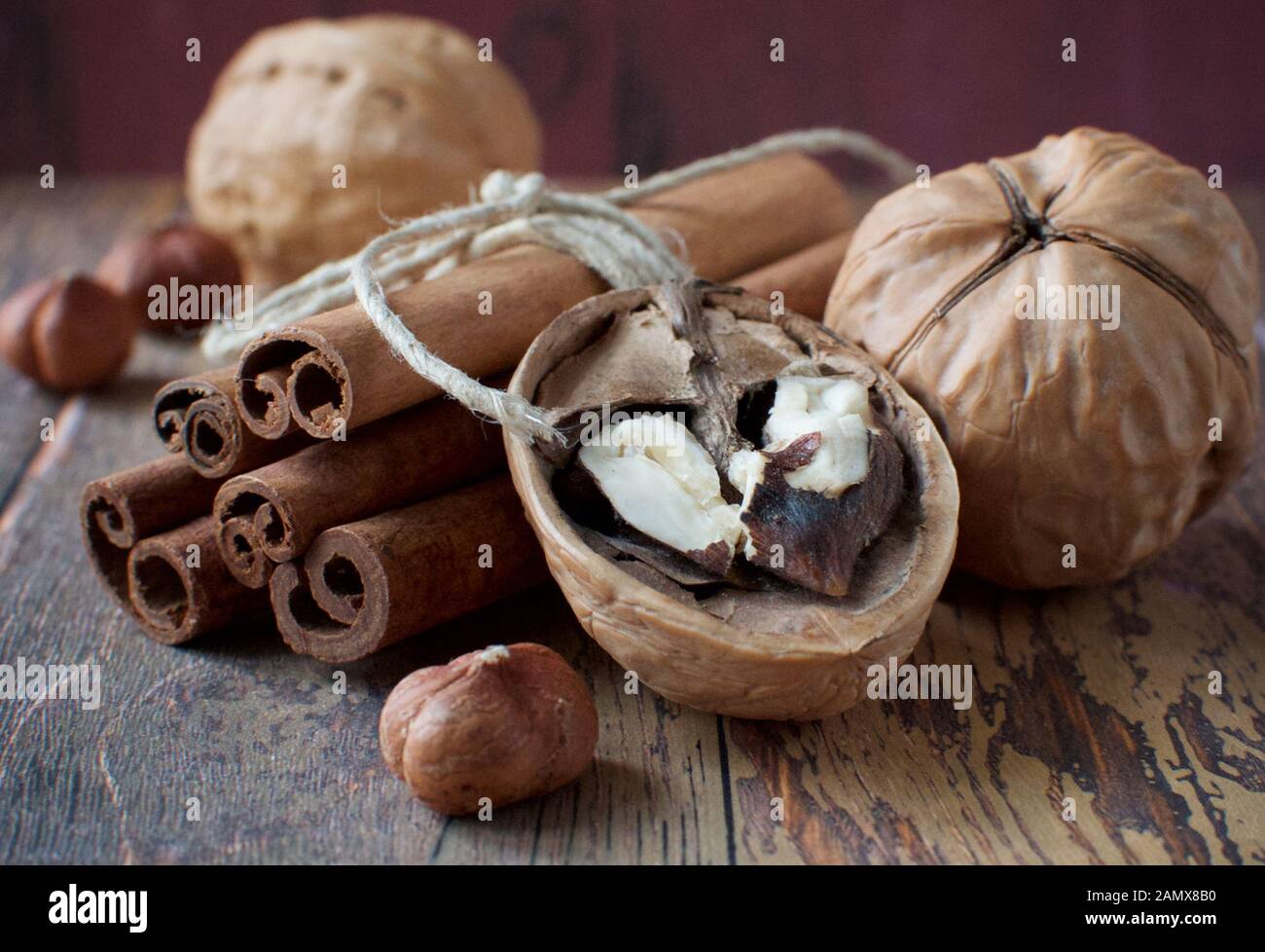 Cinnamon sticks tied with rope, walnuts and hazelnuts Stock Photo