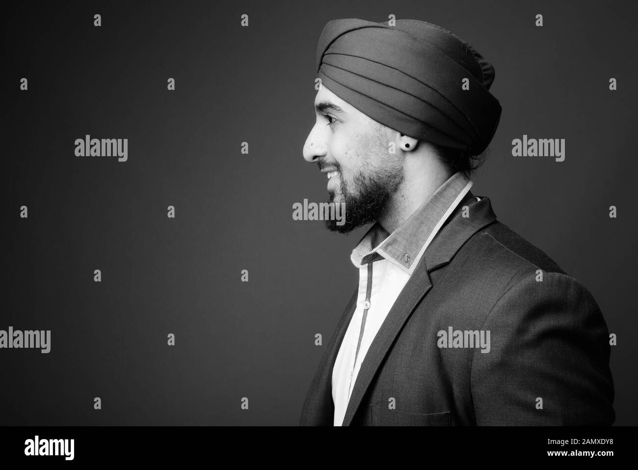 Young bearded Indian Sikh businessman wearing turban Stock Photo