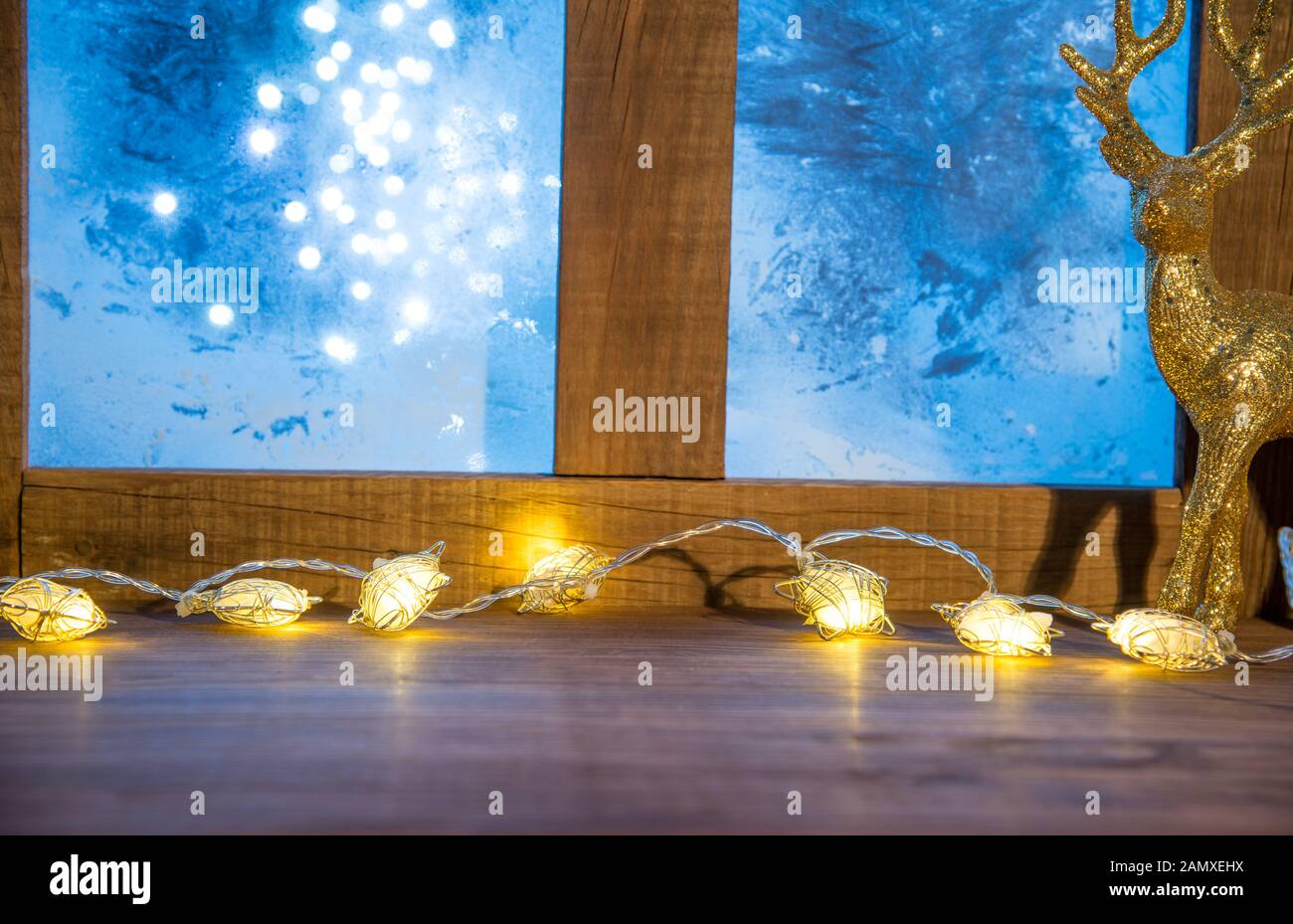 christmas cozy interior with window sill illuminated with lights Stock Photo