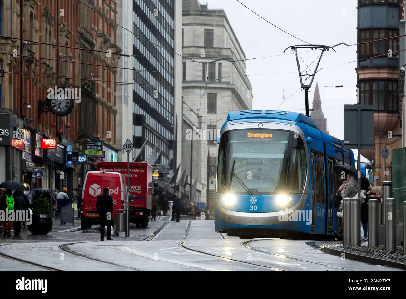 West Midlands Metro tram in wet weather in winter, Corporation Street, Birmingham city centre, UK Stock Photo