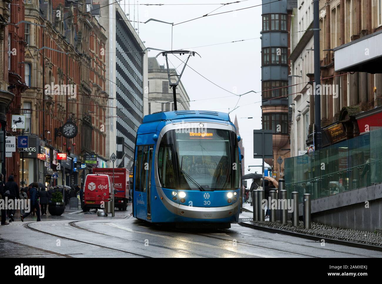 West Midlands Metro tram in wet weather in winter, Corporation Street, Birmingham city centre, UK Stock Photo