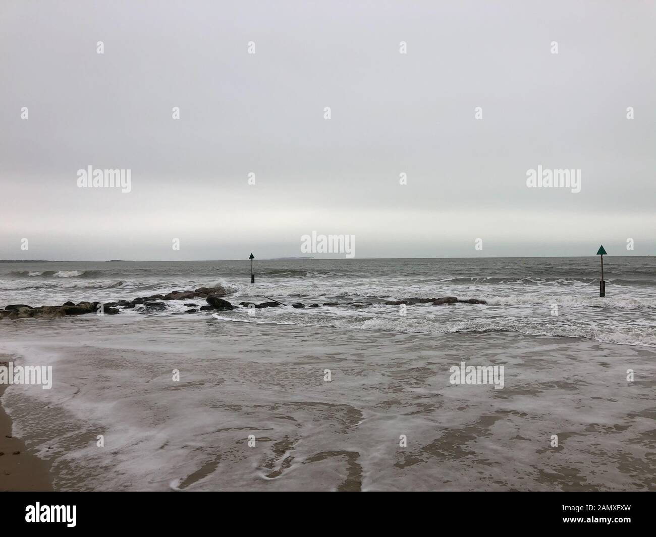 The blue flged beach of Sandbanks, showing how the sea and rain during
