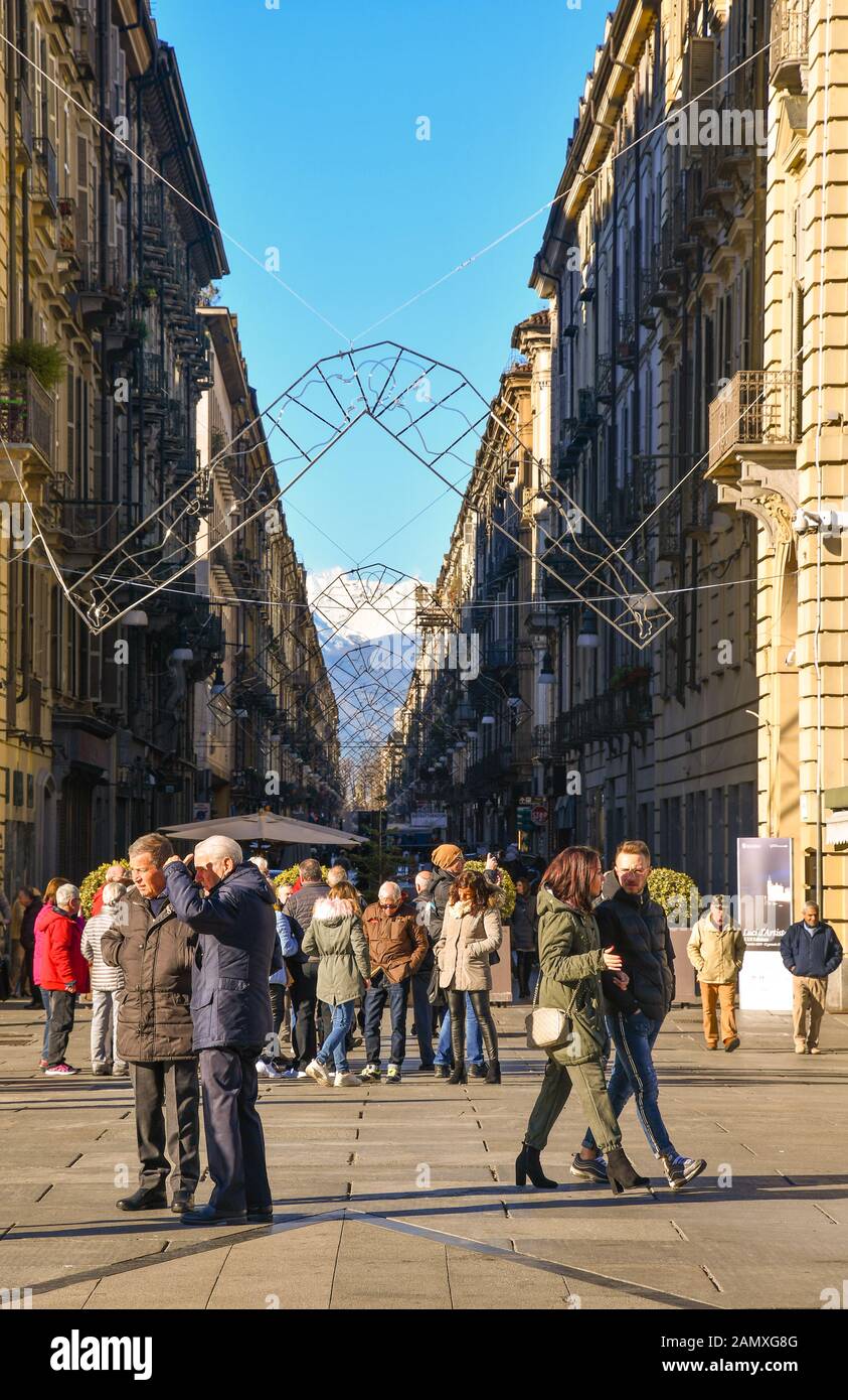 Vertical view of Via Giuseppe Garibaldi in the historic centre of Turin crowded with people on a sunny Christmas Day, Piedmont, Italy Stock Photo